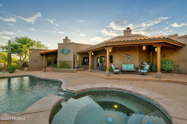 view of swimming pool with an in ground hot tub and a patio area