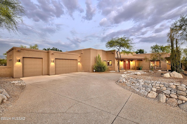 southwest-style home with a garage