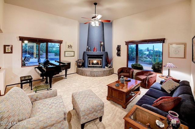 carpeted living room with ceiling fan