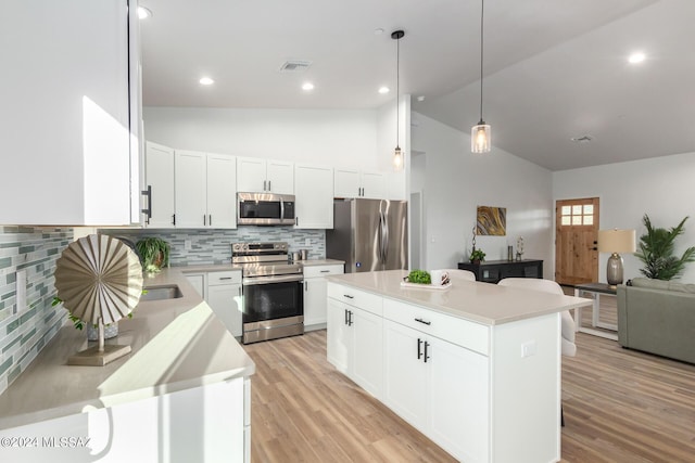 kitchen featuring visible vents, stainless steel appliances, light countertops, and light wood-style floors