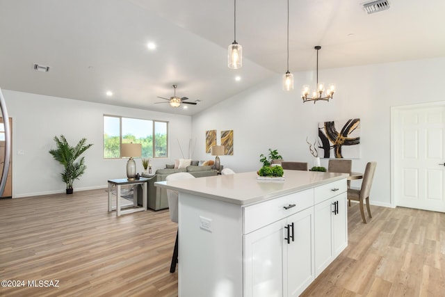 kitchen with light wood finished floors, visible vents, and lofted ceiling