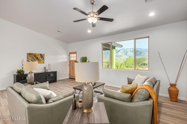 living area featuring a ceiling fan, light wood-type flooring, baseboards, visible vents, and recessed lighting