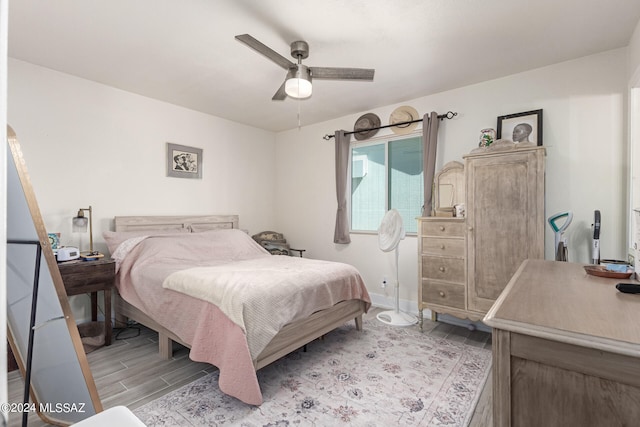 bedroom featuring light hardwood / wood-style floors and ceiling fan