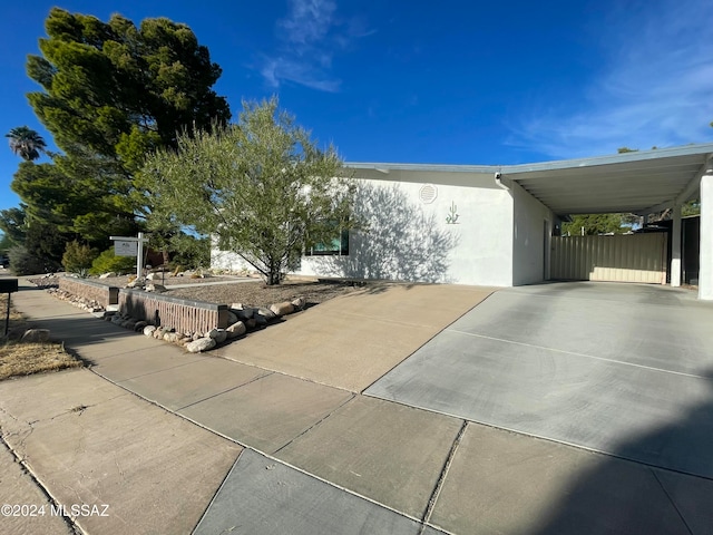 view of side of home with a carport