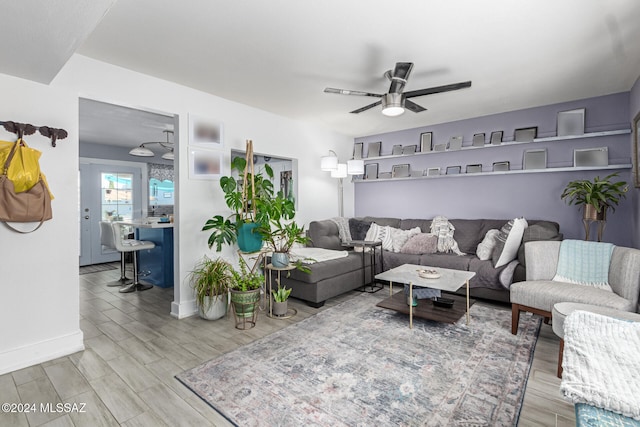 living room featuring ceiling fan and hardwood / wood-style floors