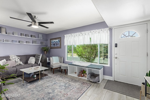 living room with light hardwood / wood-style floors and ceiling fan