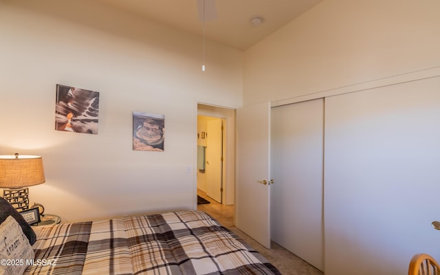 bedroom featuring a towering ceiling, a closet, and light colored carpet