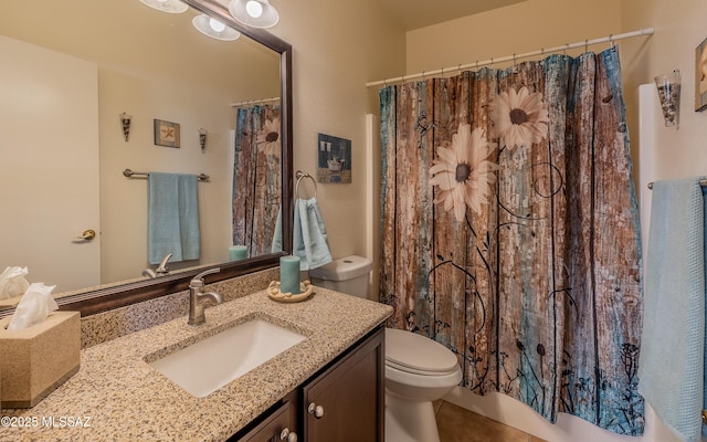 bathroom with tile patterned flooring, toilet, vanity, and curtained shower