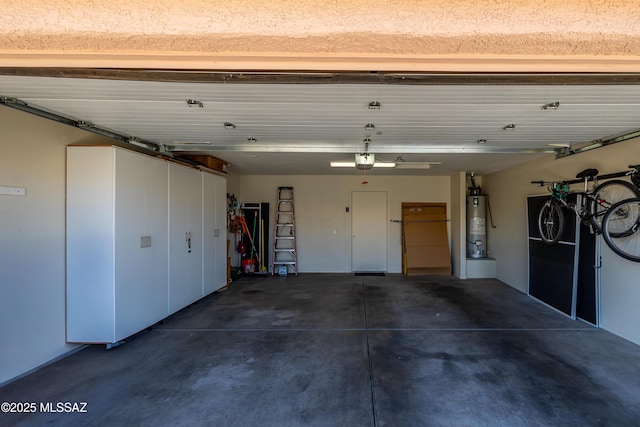 garage featuring water heater and a garage door opener