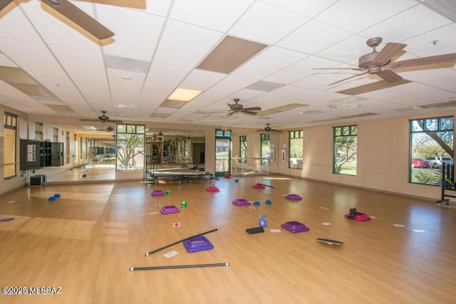 gym with plenty of natural light, wood finished floors, and ceiling fan