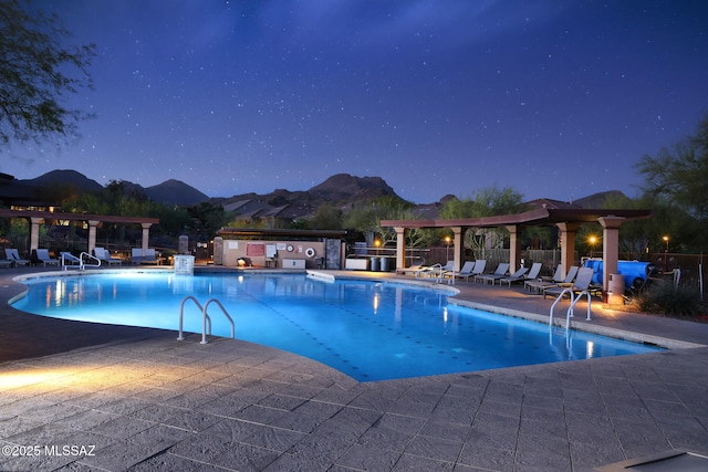 community pool with fence, a pergola, a patio area, and a mountain view