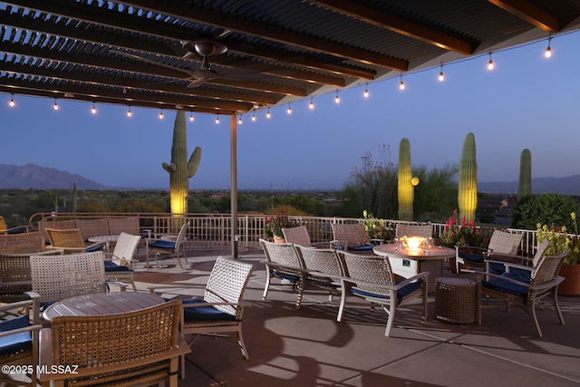 view of patio / terrace with outdoor dining space, a pergola, a fire pit, and a mountain view