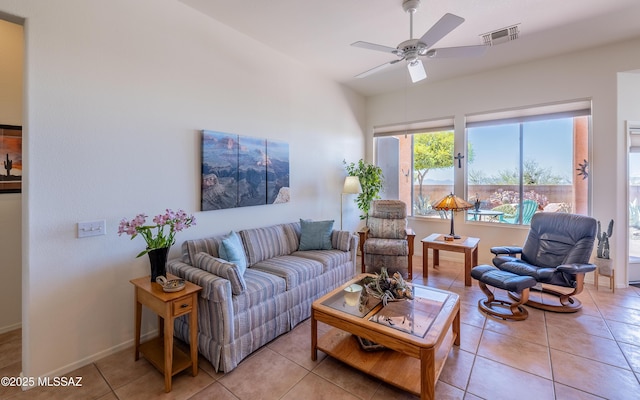 living room featuring baseboards, a ceiling fan, light tile patterned flooring, and visible vents