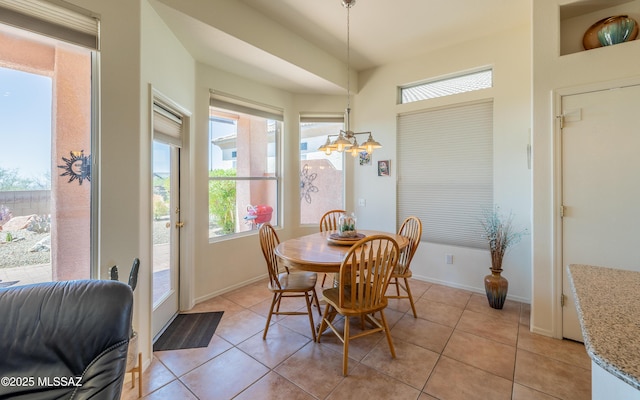 dining room featuring baseboards and light tile patterned floors