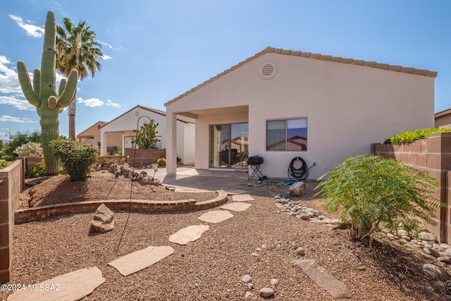 rear view of property featuring a patio