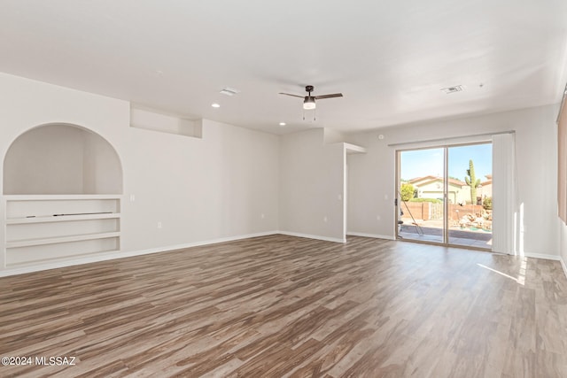 spare room with hardwood / wood-style floors and ceiling fan