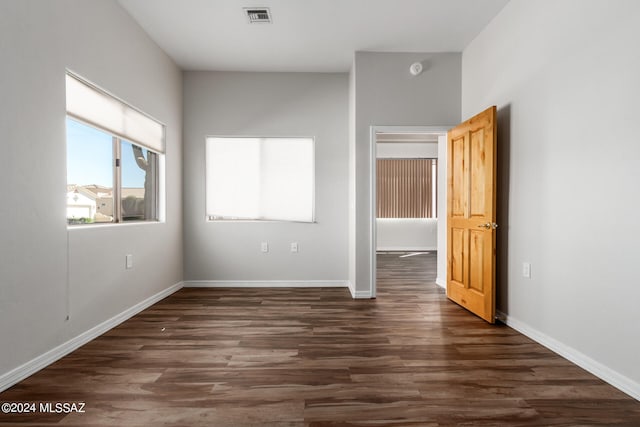 unfurnished bedroom featuring dark hardwood / wood-style floors