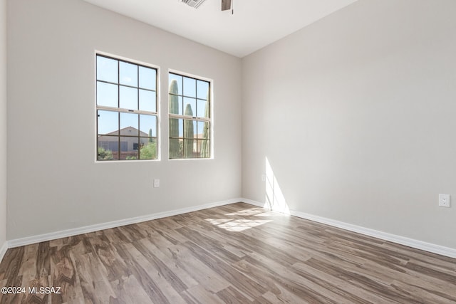 empty room with hardwood / wood-style flooring