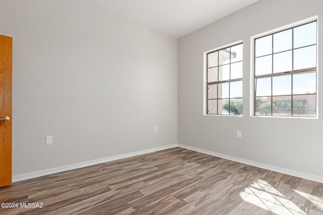 spare room with hardwood / wood-style flooring