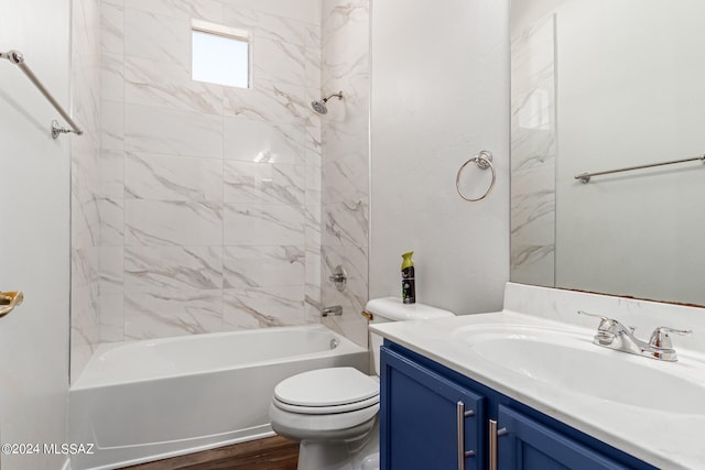 full bathroom with vanity, toilet, hardwood / wood-style flooring, and tiled shower / bath