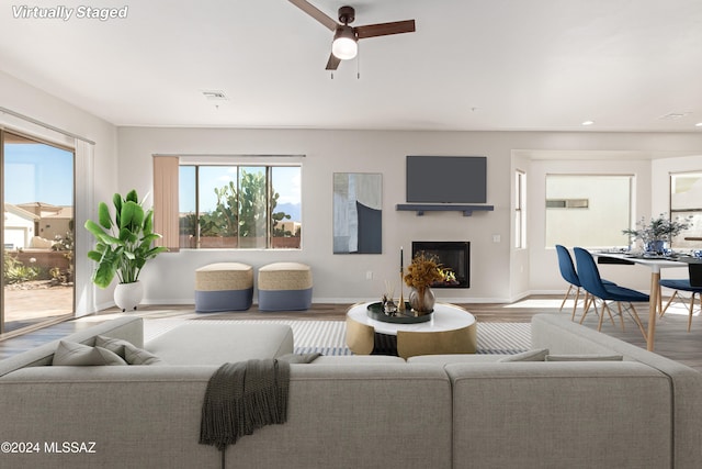 living room featuring hardwood / wood-style flooring and ceiling fan