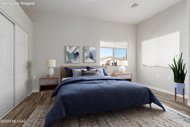 bedroom with a closet and hardwood / wood-style floors