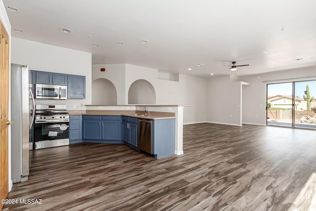 kitchen featuring blue cabinetry, stainless steel appliances, dark hardwood / wood-style flooring, and ceiling fan