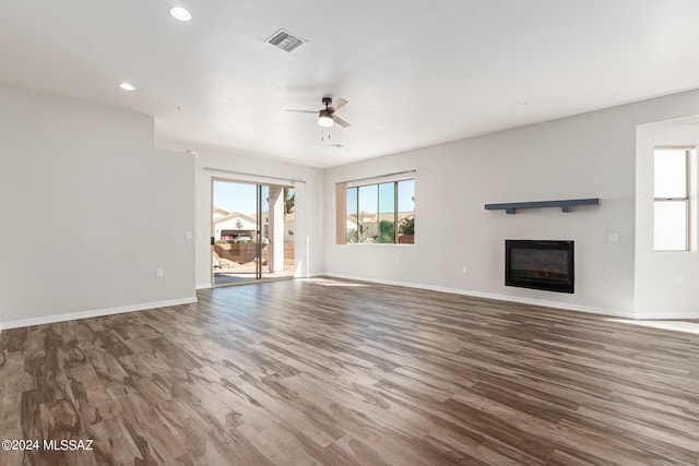 unfurnished living room featuring ceiling fan and hardwood / wood-style floors