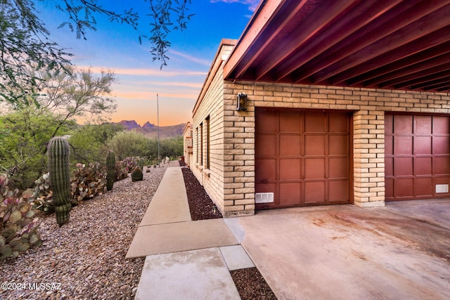 property exterior at dusk with a garage