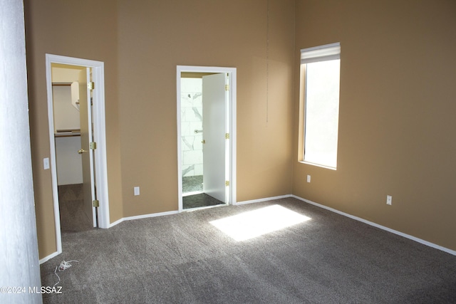 unfurnished bedroom with carpet and ensuite bath