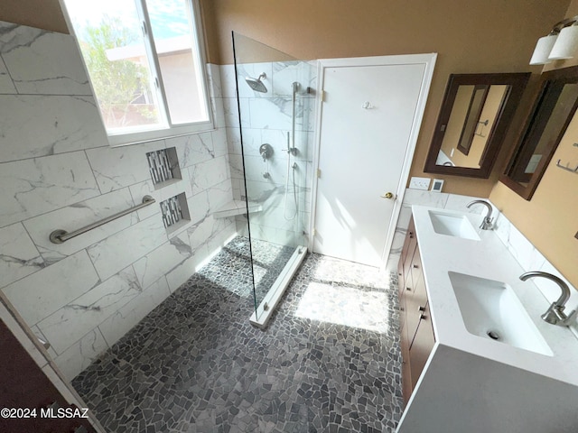 bathroom featuring vanity and a shower with door