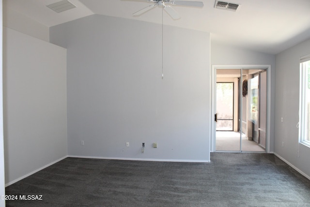 empty room featuring baseboards, visible vents, ceiling fan, and lofted ceiling
