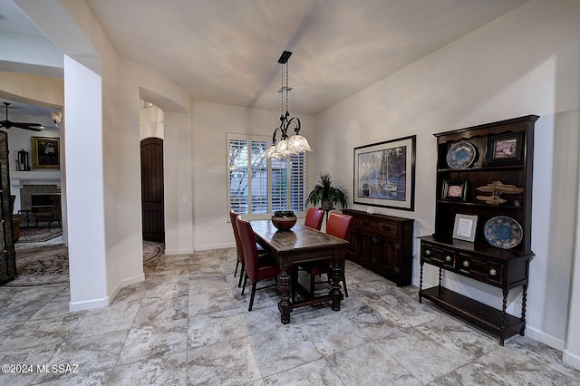 dining room featuring ceiling fan with notable chandelier