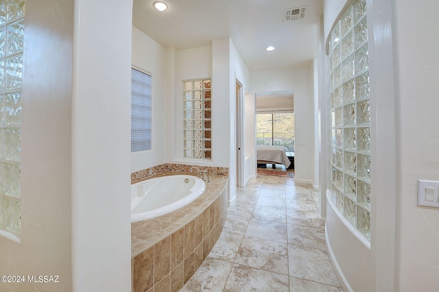 bathroom with tiled tub