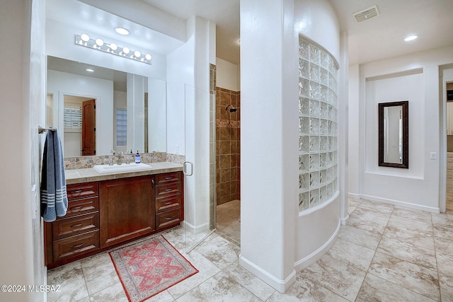 bathroom featuring vanity and a tile shower