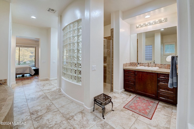 bathroom with vanity and tiled shower