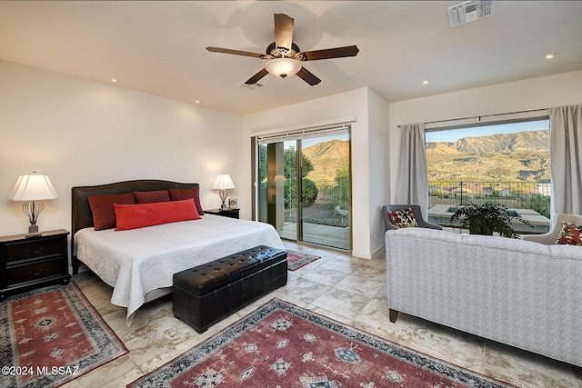 bedroom with a mountain view, access to outside, and ceiling fan