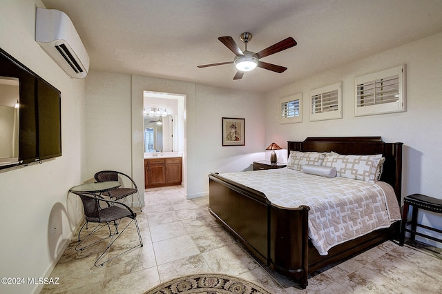 bedroom with ensuite bathroom, an AC wall unit, sink, and ceiling fan