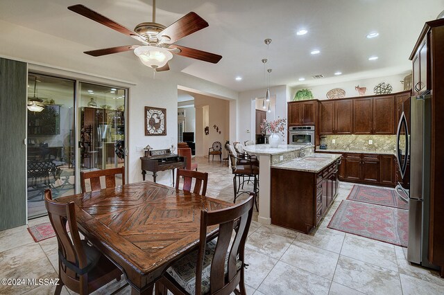 dining space featuring light tile patterned floors and ceiling fan