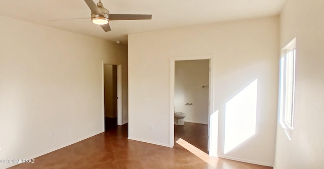 unfurnished bedroom featuring connected bathroom and ceiling fan