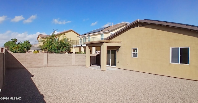 back of house featuring a patio area and a balcony