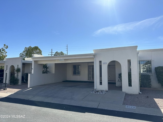 view of front of property featuring a carport