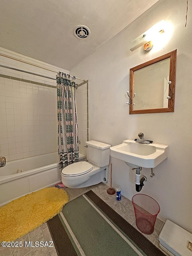 bathroom with tile patterned floors, a sink, toilet, visible vents, and shower / bathtub combination with curtain
