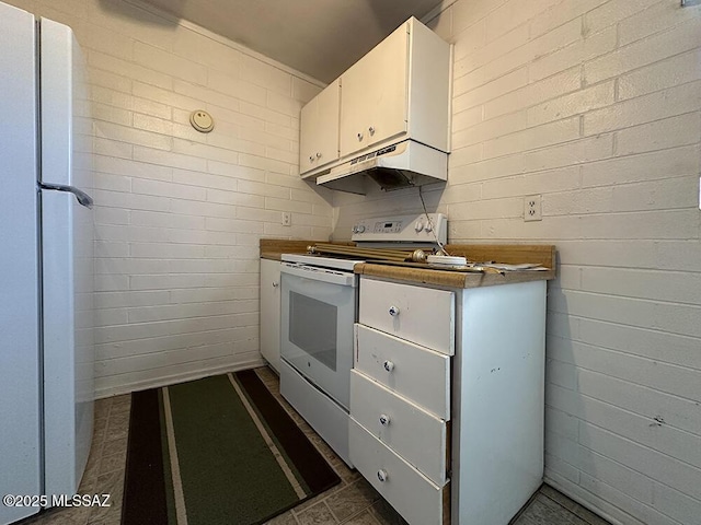 kitchen featuring white cabinets, under cabinet range hood, and white appliances