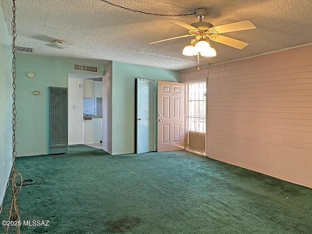 unfurnished room featuring a ceiling fan, carpet flooring, a textured ceiling, and visible vents
