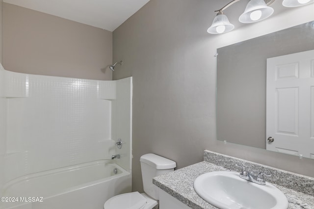 full bathroom featuring bathing tub / shower combination, vanity, and toilet