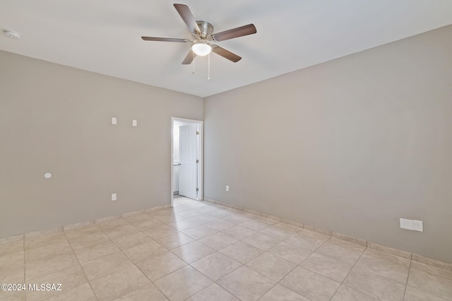 tiled spare room with ceiling fan