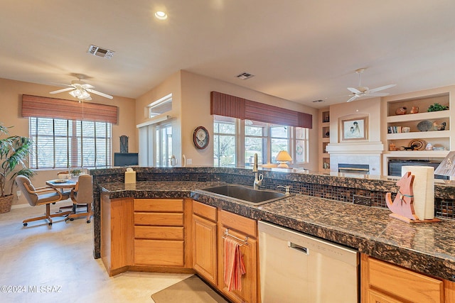 kitchen featuring built in features, sink, stainless steel dishwasher, and ceiling fan