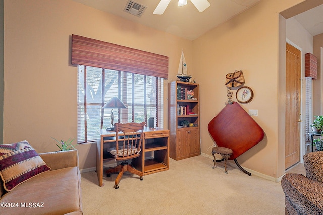 carpeted home office featuring ceiling fan