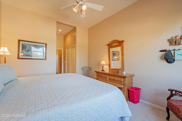 carpeted bedroom featuring lofted ceiling, a closet, and ceiling fan